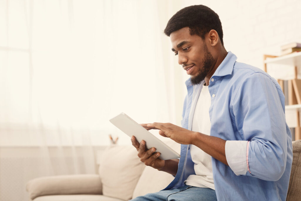man searching online using tablet